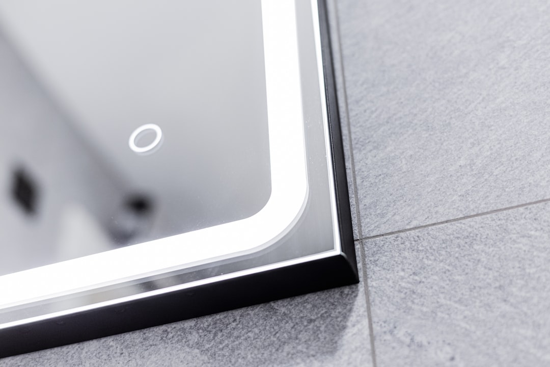 Modern illuminated bathroom mirror with black frame